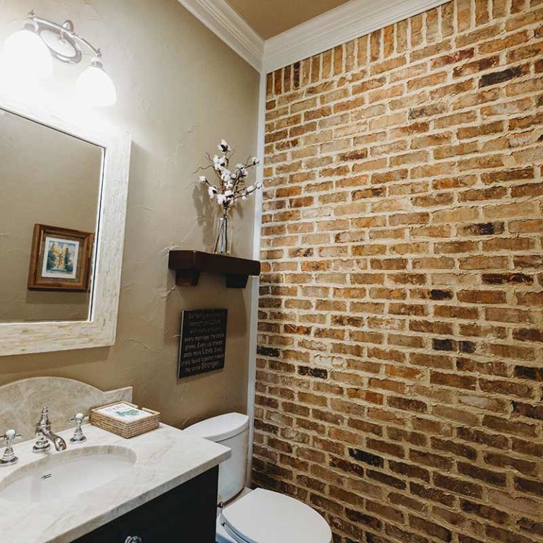 Rustic brick wall powder room.