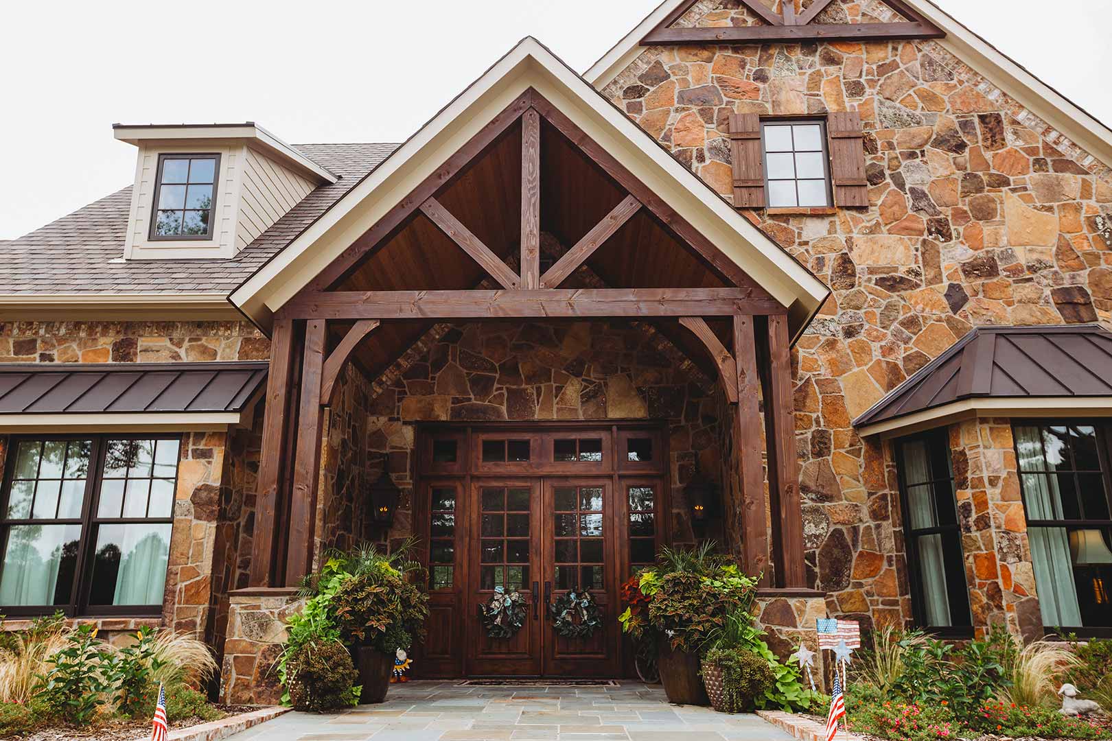 Stone house entrance with wooden beams.