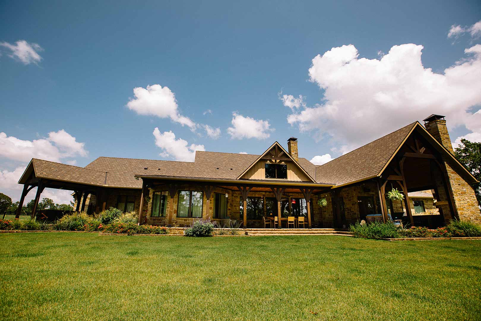 Stone house with large covered patio.