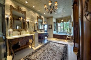 Luxurious ornate bathroom with large mirrors.
