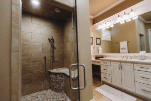 Luxury walk-in shower with stone seat.